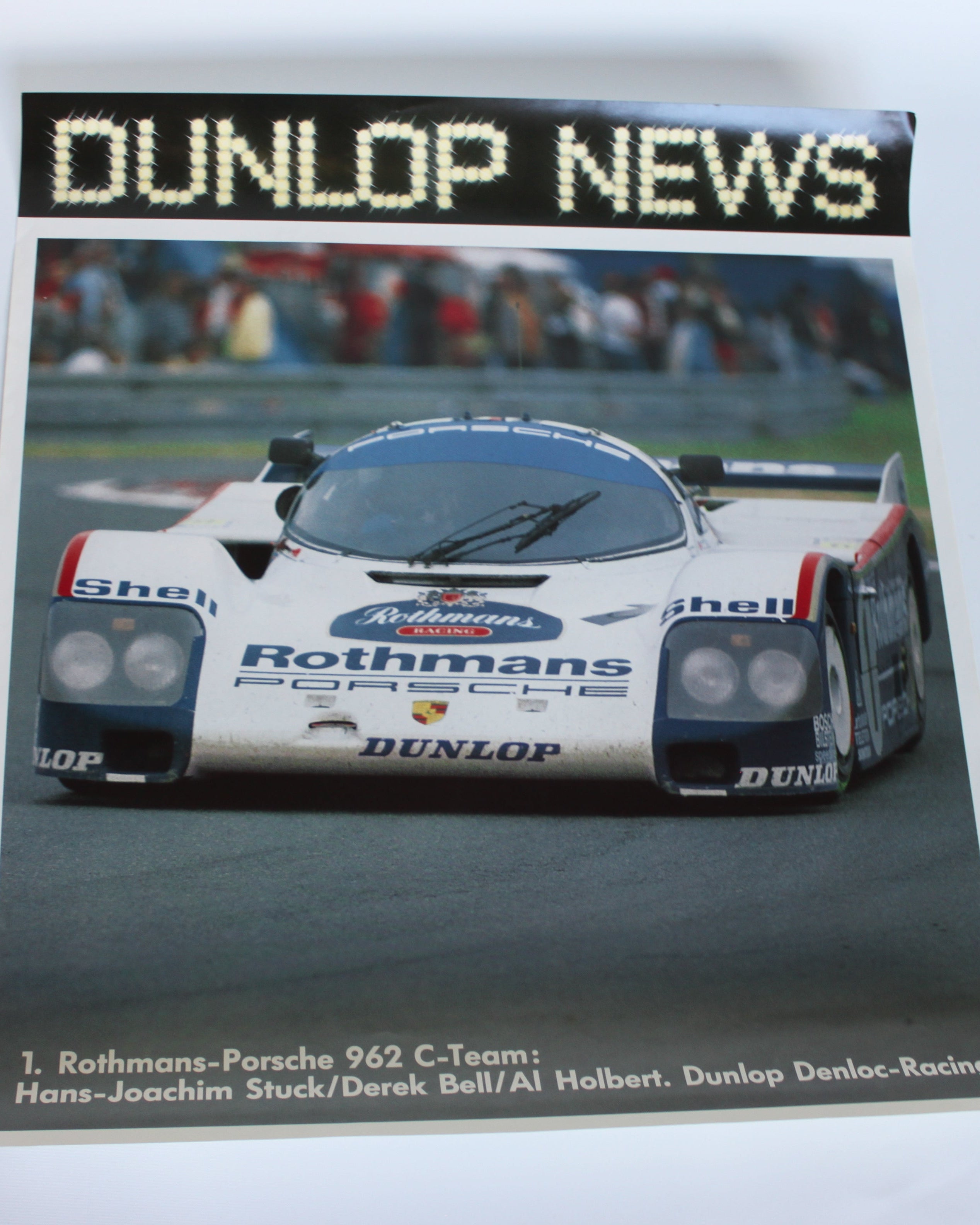 1980s Dunlop News motorsport poster featuring the Rothmans-liveried Porsche 962