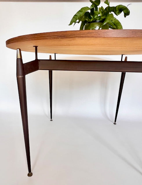 Sculptural metal legs of a Grant Featherston Aristoc Scape table supporting a laminate top