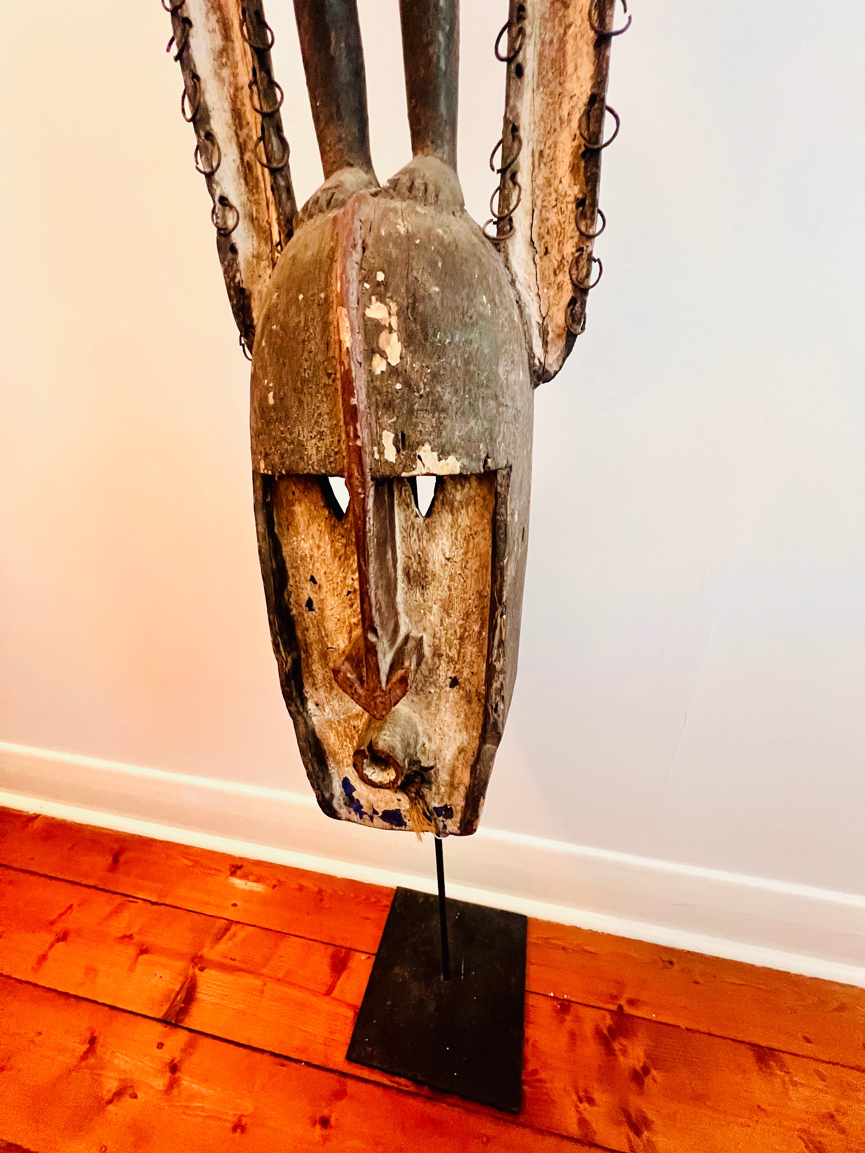 Dogon carved timber sculptural figure from Mali, surmounted female figure above mask form, displayed on metal stand