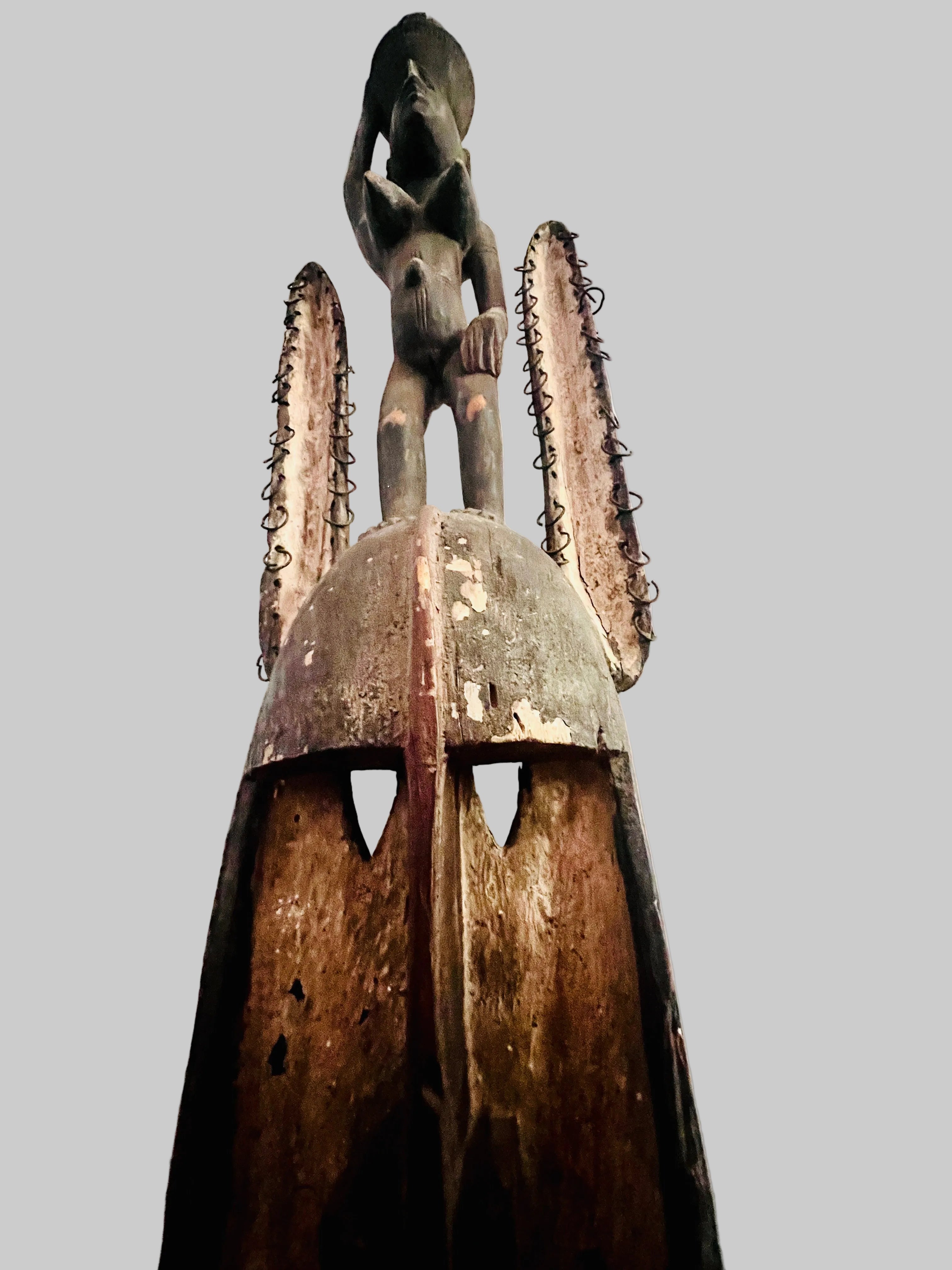 Dogon carved timber sculptural figure from Mali, surmounted female figure above mask form, displayed on metal stand. Showing rabit mask and figure