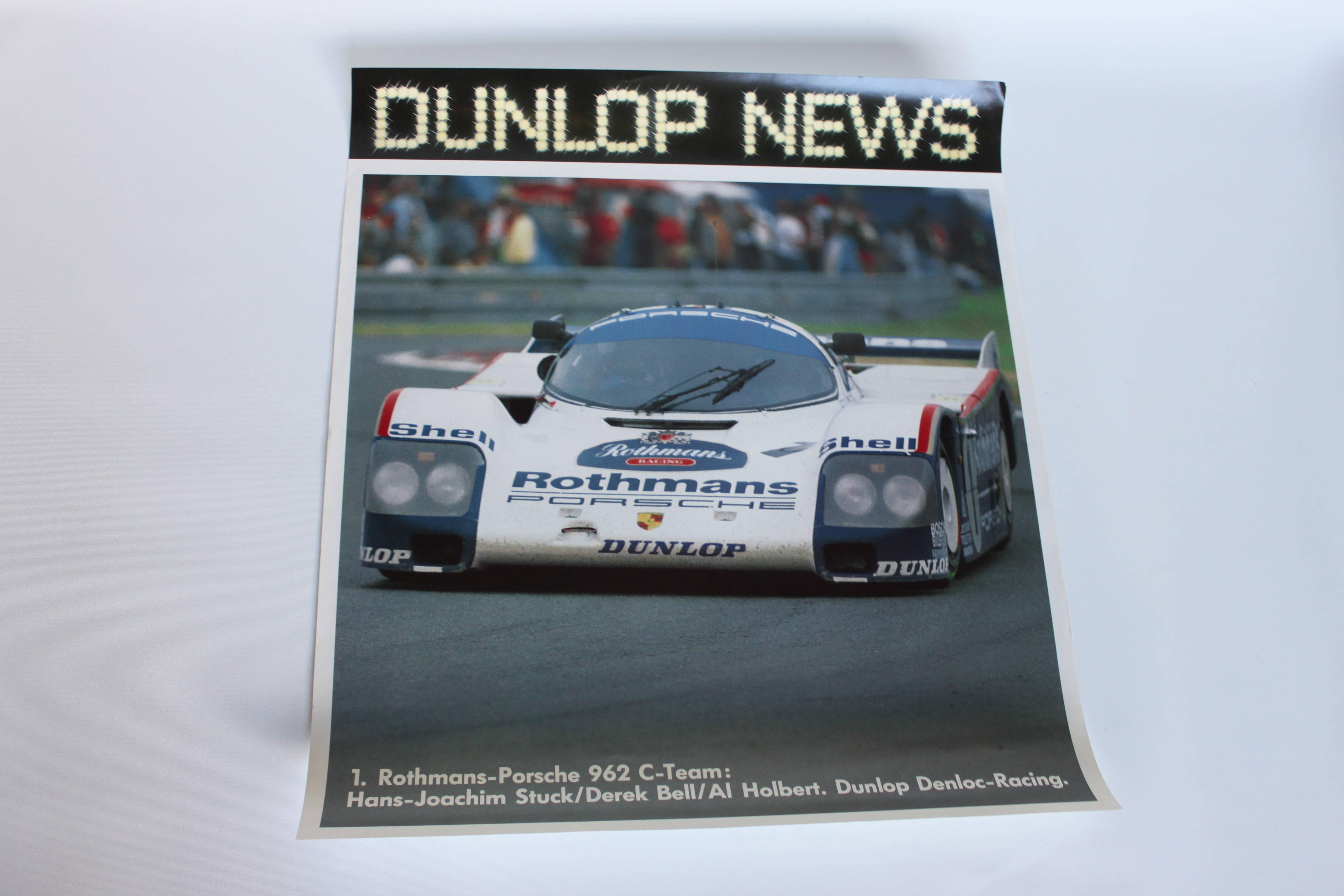 1980s Dunlop News motorsport poster featuring the Rothmans-liveried Porsche 962 