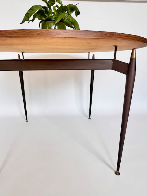 Sculptural metal legs of a Grant Featherston Aristoc Scape table supporting a laminate top
