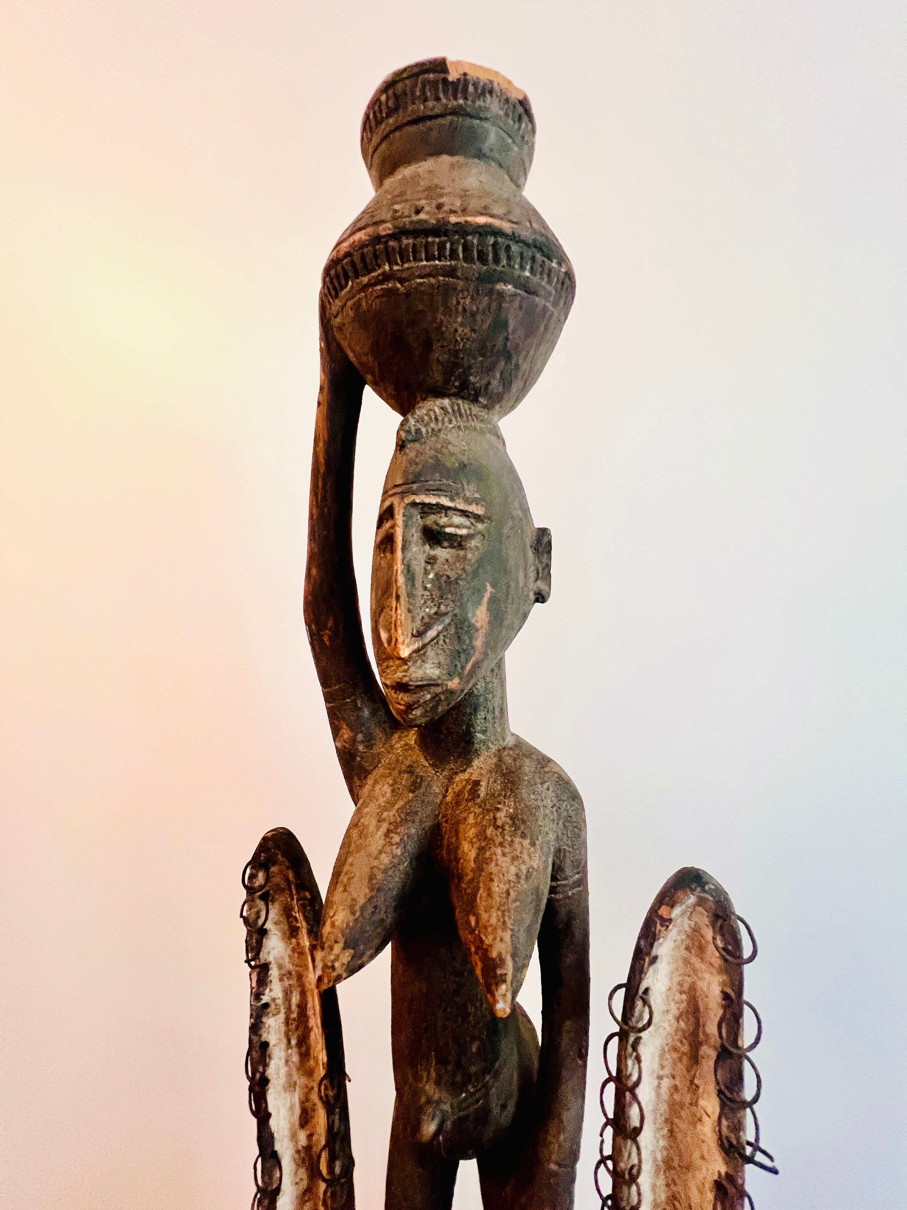 Dogon carved timber sculptural figure from Mali, surmounted female figure above mask form, displayed on metal stand showing upper figure